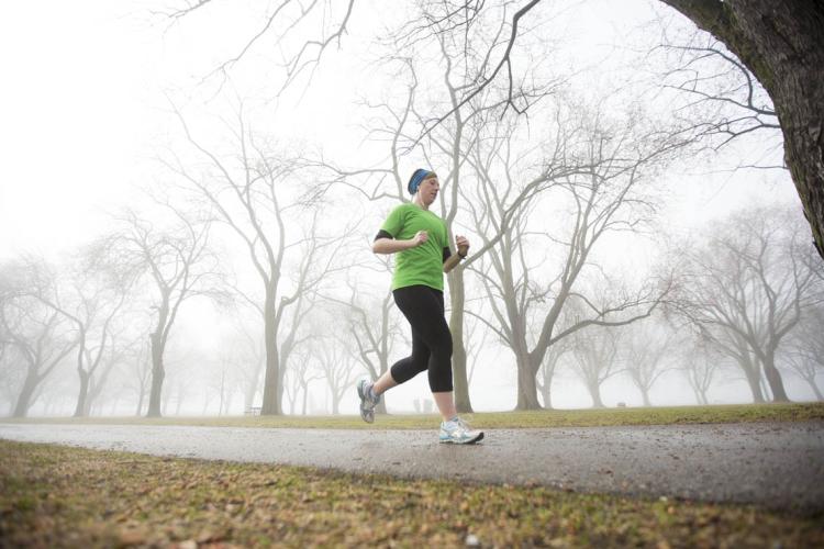 Woman jogging on a foggy morning