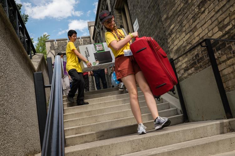 Photo of students bring their things to their dorms