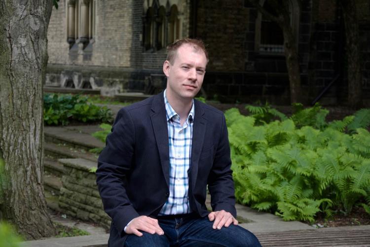 Markus Schafer on a bench at the University of Toronto