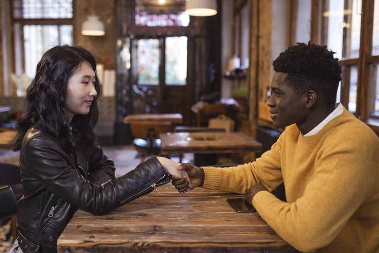 an east asian woman and a black man on a first date