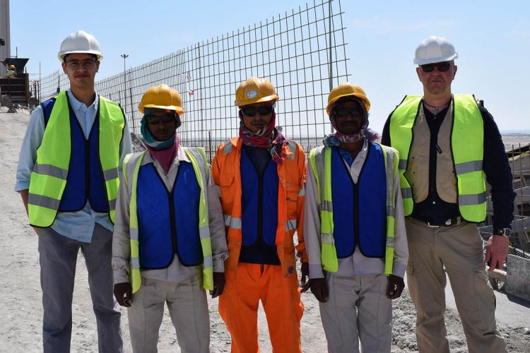 Adam Sheikh and workers demonstrate the cooling vests