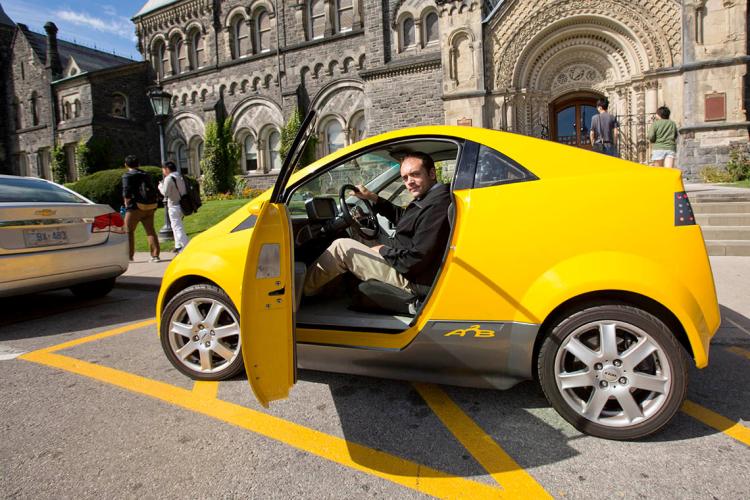 Photo of Olivier Trescases sitting in an electric car