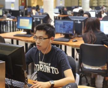 Students studying a computer.