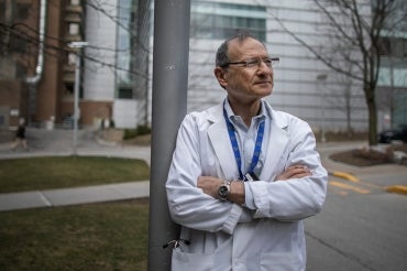 Photo of Joe Fisher, wearing a white lab coat