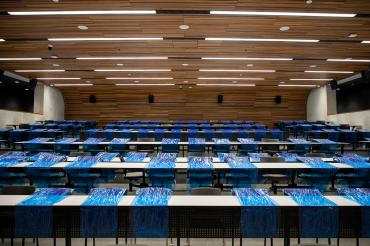 Shot of a lecture hall at U of T Mississauga with blue shrink wrap blocking off the majority of desks