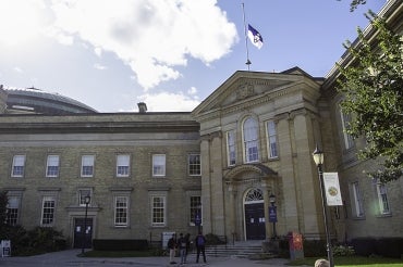 Simcoe Hall with the University flag at half-mast 