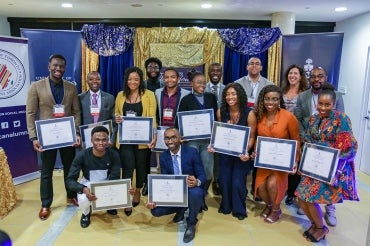 Group photo of the African Scholar awards winners holding up their awards