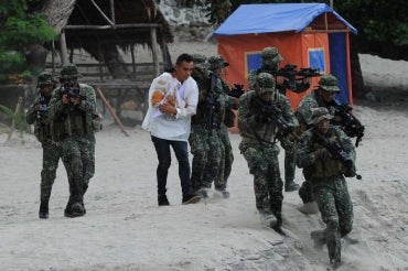Philippine soldiers carry out a mock hostage rescue exercise