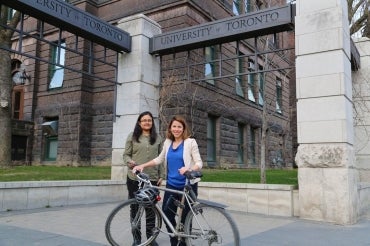  photo of Sabreena Anowar and Professor Mariann Hatzopoulou  with a bike 