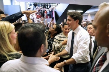 photo of Trudeau greeting crowd of students