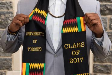 U of T grad shows off a scarf his sister gave him as a grad gift