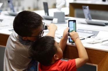 Photo of children using smartphone