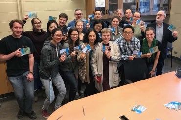 Photo of students with signed postcards