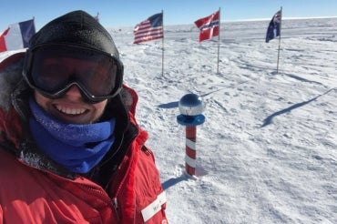 photo of PhD student in winter gear at South Pole