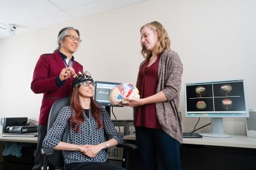 Photo of Tom Chau and two graduate students