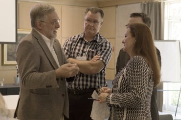 photo of John Robinson talking to Patricia Koval