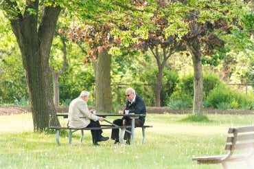 Photo of two men sitting on a Toronto park bench