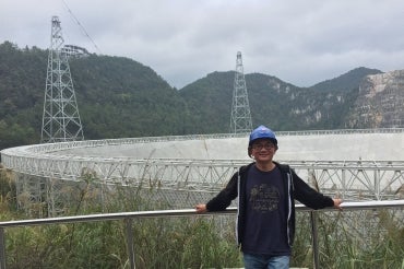 photo of Ue-Li Pen at the FAST radio telescope in China