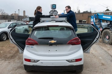 Photo of students working on Zeus, a self-driving vehicle