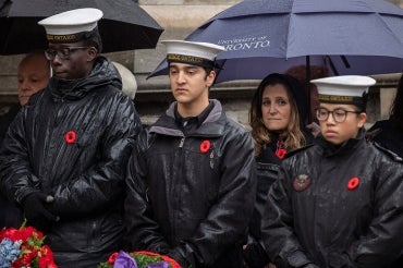 Photo of Chrystia Freeland standing under an umbrella