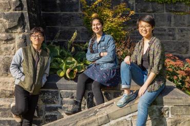 Chan-min Roh, Abnash Bassi and Shiqi Xu pose outside University College on a sunny fall day