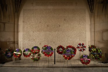 wreaths are laid in front of the memorial wall undernearth soldier's tower at the University of Toronto