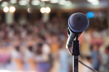A microphone in front of an audience.