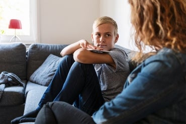 boy looks pensively at mother