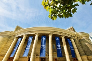 Convocation hall with banners that say "congratulations to all our graduates"