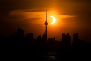 Sun rising behind the Toronto skyline during an annular eclipse