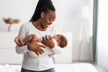 Woman holding a baby while singing