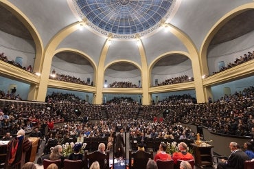a wide view of a full convocation hall as seen from the stage