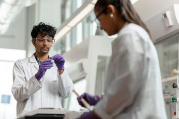 Two students performing experiments in a laboratory on U of T campus