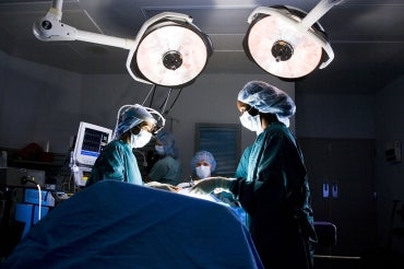 female surgeons operate on a patient