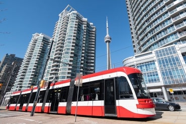A streetcar drives down the waterfront in downtown Toronto