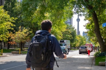 Student walks down St. George st. at the University of Toronto St. George campus