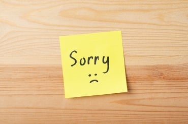 word "sorry" written on a sticky note
