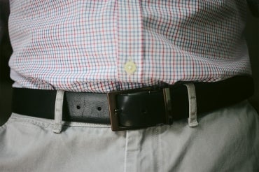 close up of a man's waist wearing shirt, pants and a belt