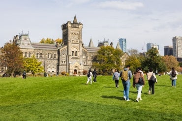 Students walking across the front campus lawn