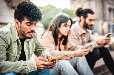 group of university students on mobile devices