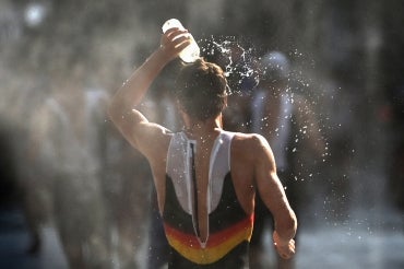 Runner pouring water on heat