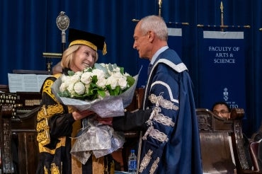 President Meric Gertler presents Chancellor Rose Patten with a bouquet at the conclusion of her 133rd convocation ceremony.