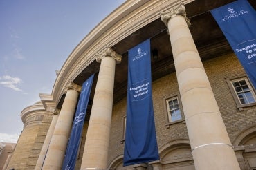 exterior view of convocation hall showing graduation banners