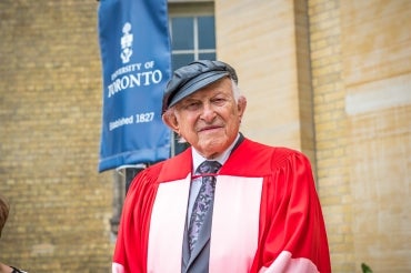 Nathan Liepciger stands outside Simcoe Hall before receiving his honorary degree