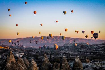Photo of balloons taking to the sky over Göreme,Turkey