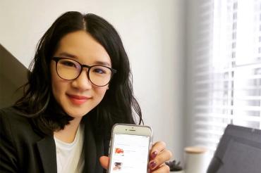 Catherine Chan holds up a cellphone
