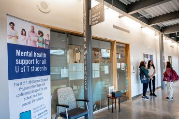 students stand outside the Health and Wellness Centre at UTSC