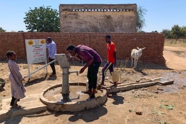 A man drinks from a well in Sudan