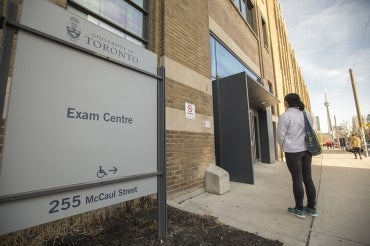 Photo of A. Zhang in front of the Exam Centre