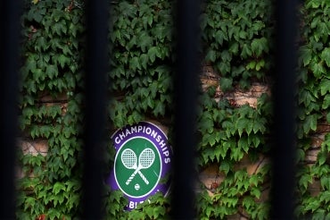 the wimbledon logo is seen through a set of black bars